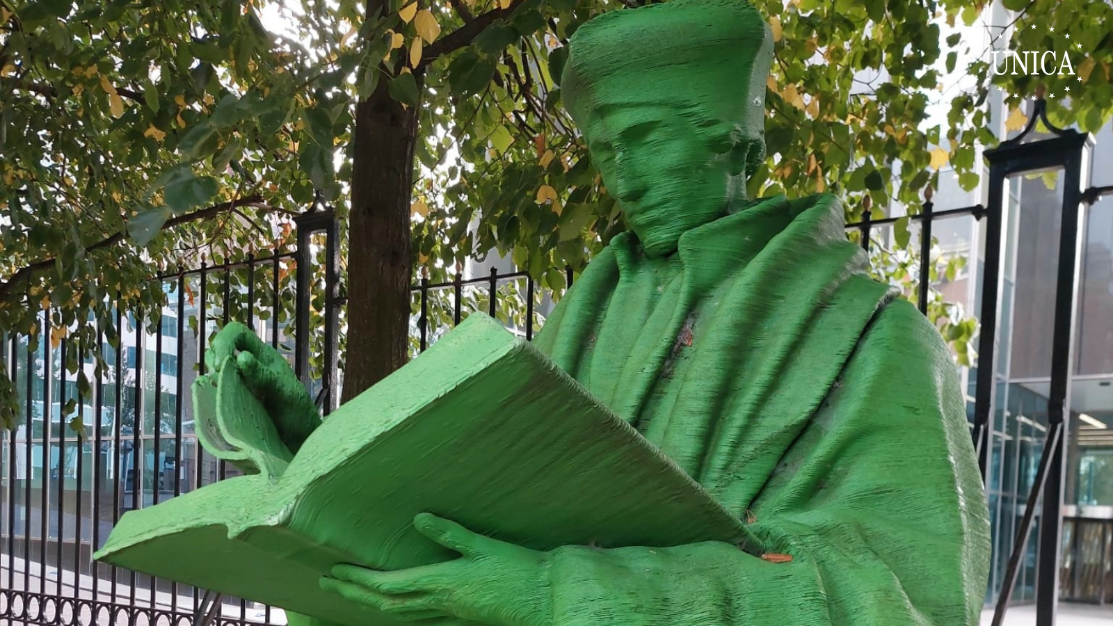 Green statue of Erasmus of Rotterdam with an open book, printed in 3D