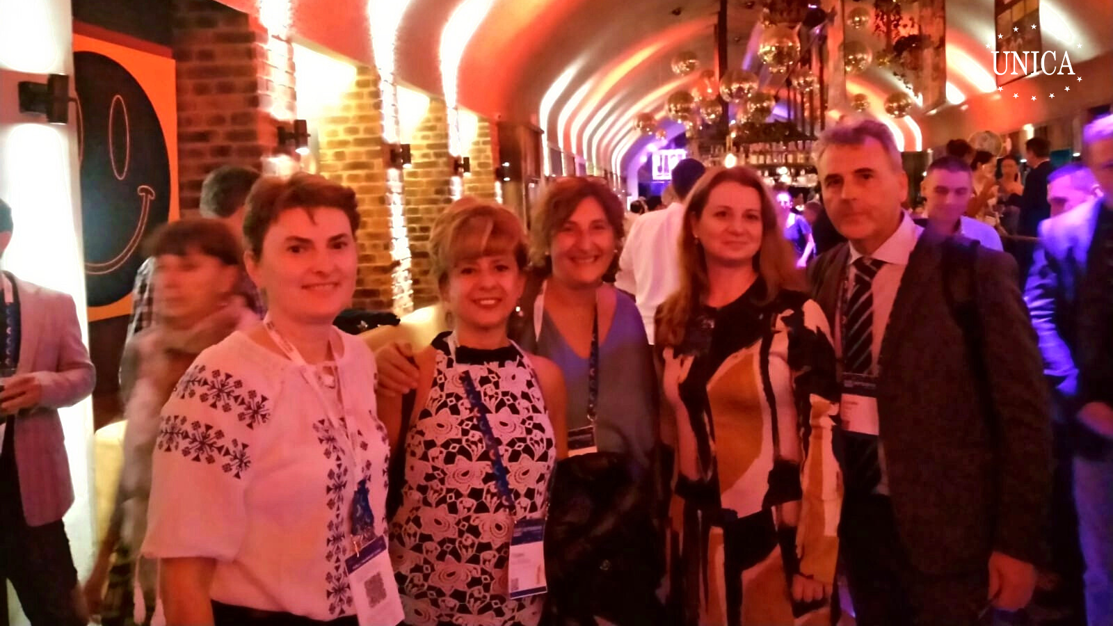 4 women and 1 man posing for a picture in a bar