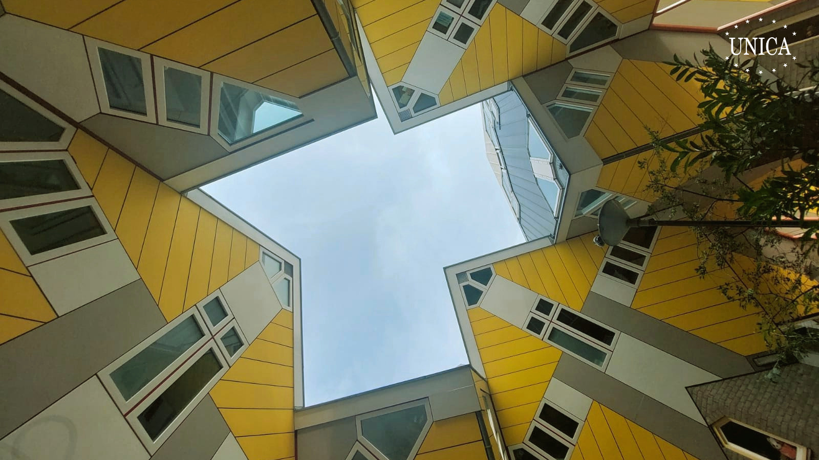 Creative view of a group of yellow houses in Rotterdam. Sky is seen in the middle.
